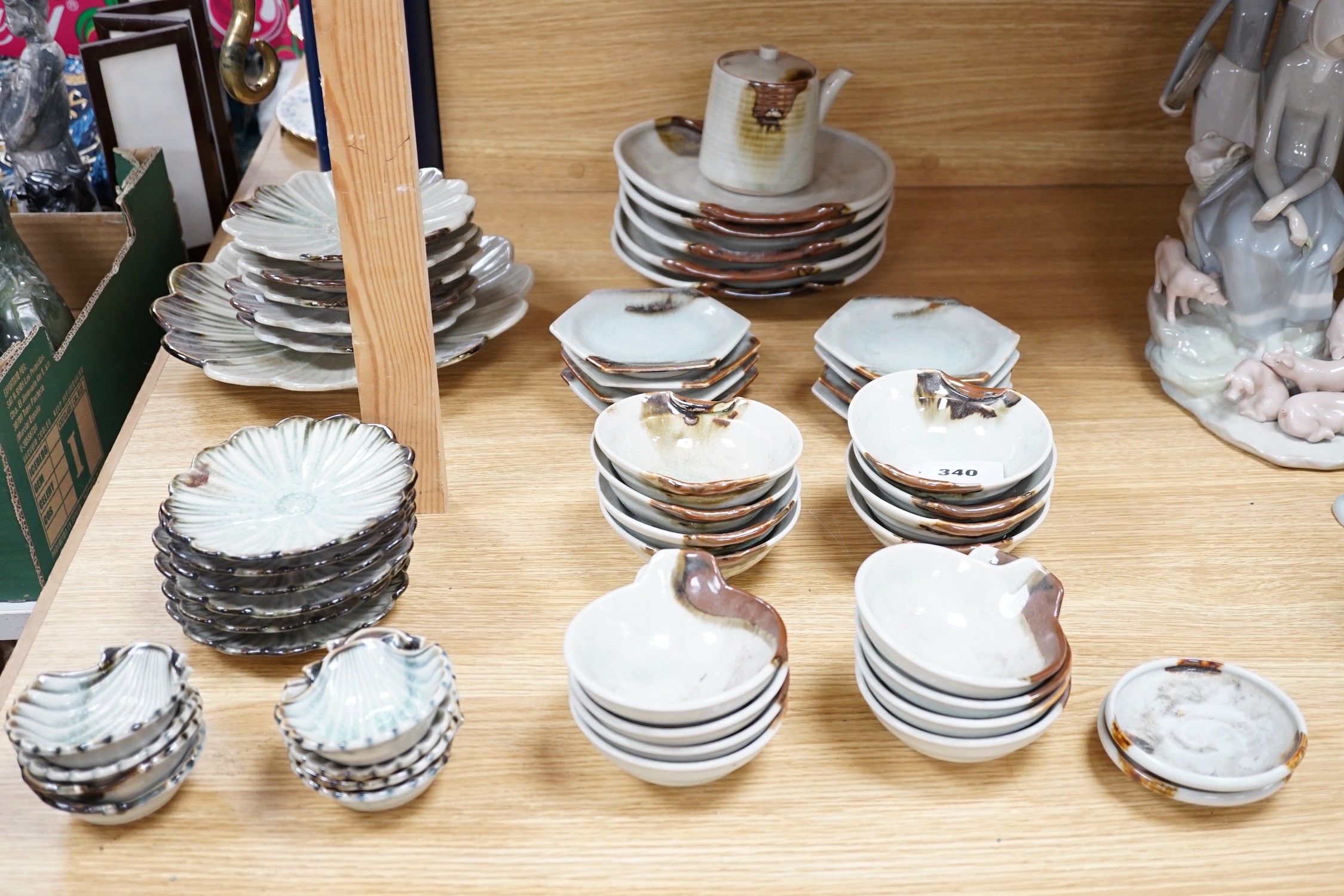 A group of Japanese studio pottery bowls, shell dishes, plates and a teapot, approx 53 pieces